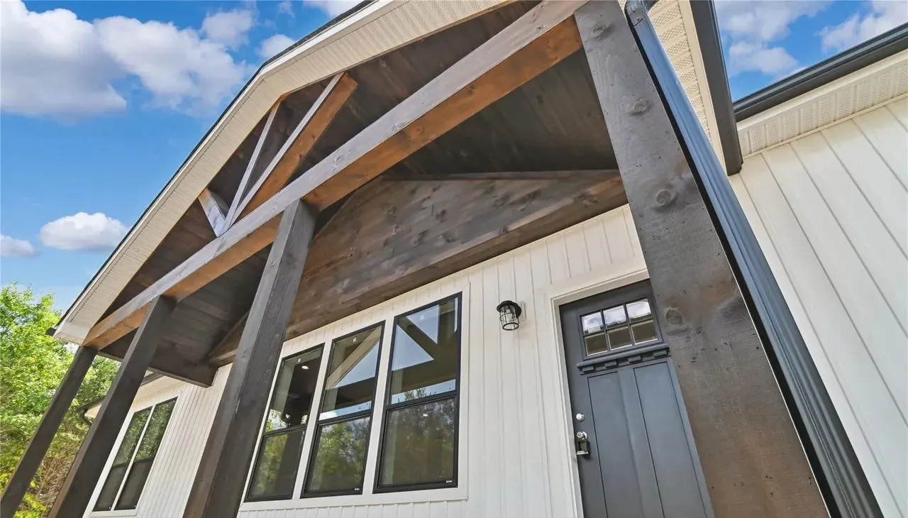 Timber-framed covered front porch on a new home built by Hart Homes