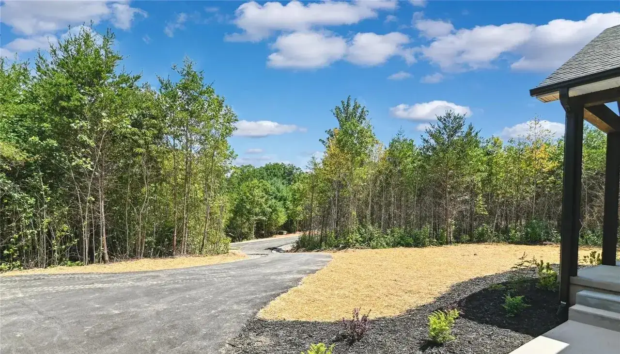 Asphalt driveway, mulch beds and new landscaping at a home finished by Hart Homes